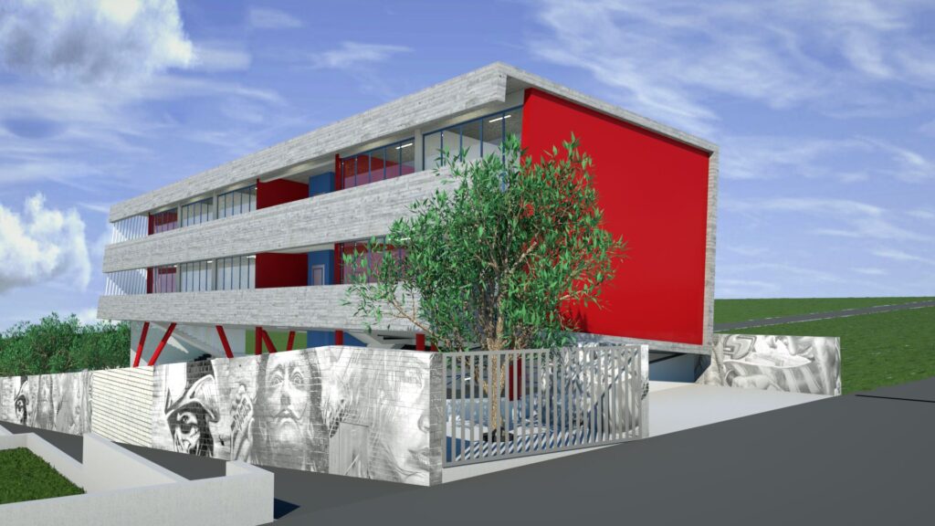 A modern two-story school building with a striking red and gray color scheme. The facade features a combination of textured gray concrete panels and vibrant red accents, with rows of windows. A metal fence with vertical bars partially obscures the view of the entrance, which is adorned with mural artwork. Lush green trees and landscaping surround the building, set against a bright blue sky with fluffy white clouds. By Modify Architects